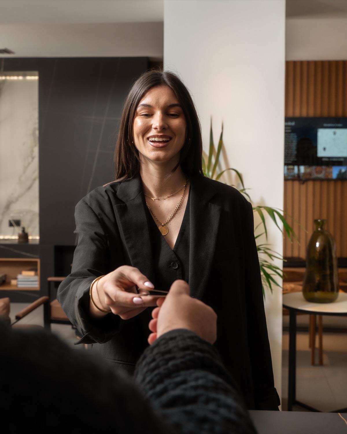 A member of staff welcoming a guest at reception